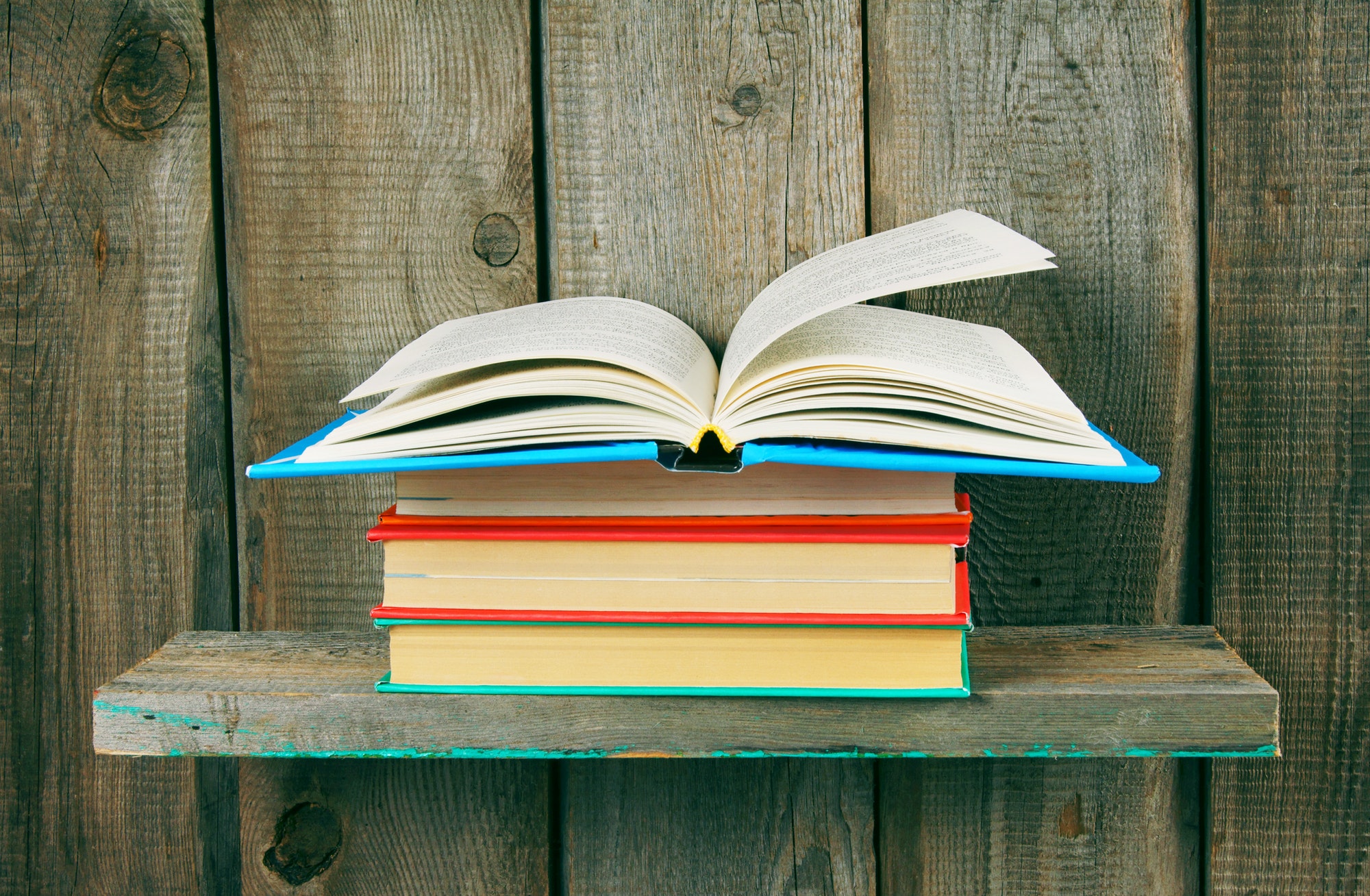 The open book on a pile from books.